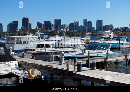 Boats moored on pontoons on the Charles River, with the skyline of Boston, Massachusetts in the background Stock Photo