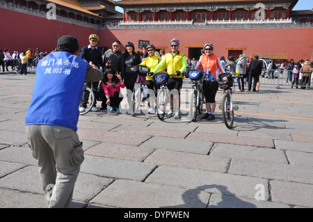 Chinese tourists taking photo with Australian cyclists Forbidden City, Beijing, China, a UNESCO World Heritage Site. Stock Photo