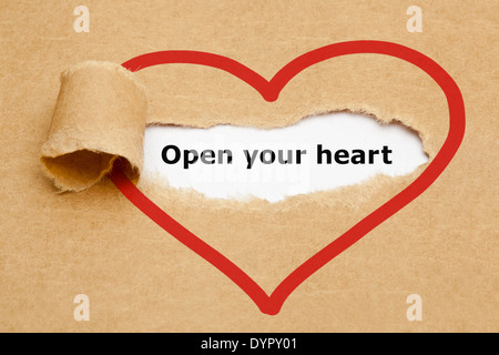 Open your heart, appearing behind torn brown paper. Stock Photo