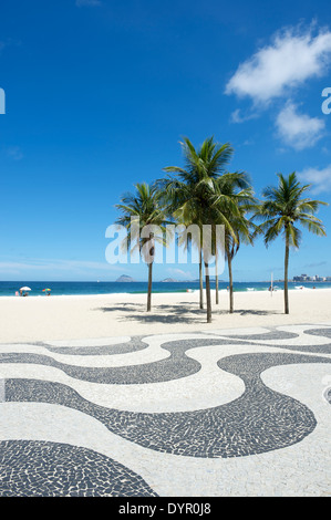 Iconic sidewalk tile pattern with palm trees at Copacabana Beach Rio de Janeiro Brazil Stock Photo