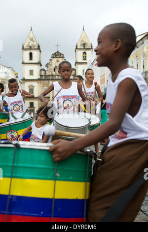 SALVADOR, BRAZIL - OCTOBER 15, 2013: Brazilian children stand drumming in a group in the historical center of Pelourinho, famous Stock Photo