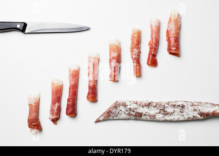 Rolls of Spanish ham, chorizo and fuet sausages Stock Photo