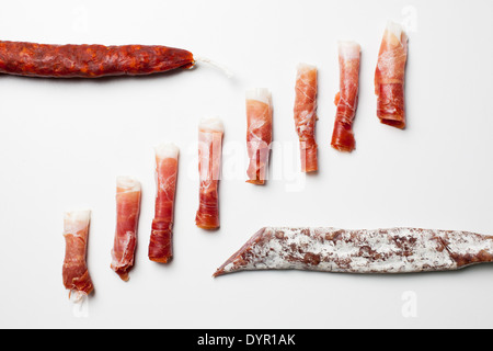 Rolls of Spanish ham, chorizo and fuet sausages Stock Photo