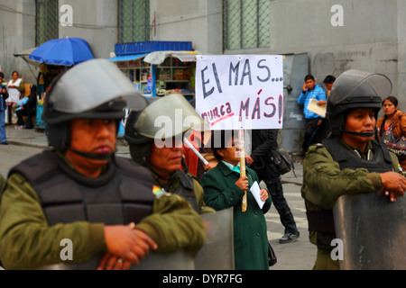 A retired teacher holds an anti government sign during a protest march demanding increased pension payments, La Paz, Bolivia Stock Photo