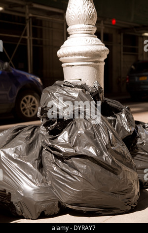 Big pile of black plastic garbage bags with trash stacked on the street trash  bags. on the street at utility workers strike day Stock Photo - Alamy