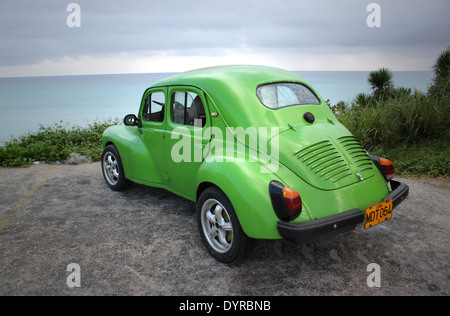 Old American green car in Varadero, Cuba, parked on a plateau overlooking Caribbean sea Stock Photo