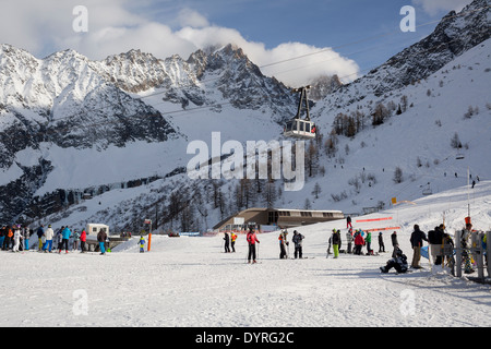 Skiers bask in the sun at the Lognan lift area, the halfway point to the top of Grands Montets. Stock Photo