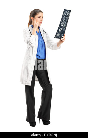 Full length portrait of a female doctor analyzing an x-ray Stock Photo