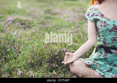 Pretty woman meditate in the park Stock Photo