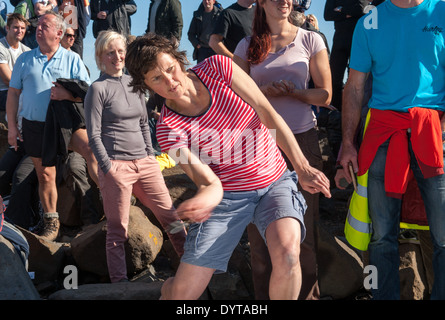 A woman competes in the World Stone Skimming Championship.Easdale, Scotland, UK. 29 Sept 2013. Stock Photo