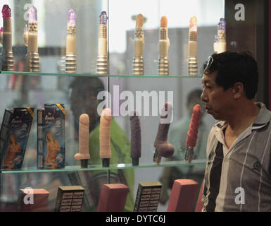 A man looks at sex toy display in a three day China International