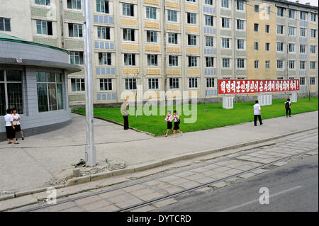 People walk on a sidewalk in Central Pyongyang Stock Photo