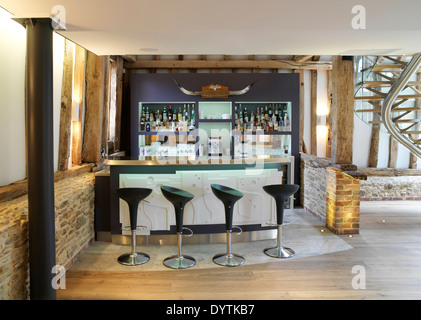 Home bar in barn conversion with exposed beams, Field Place Barns, Surrey Stock Photo