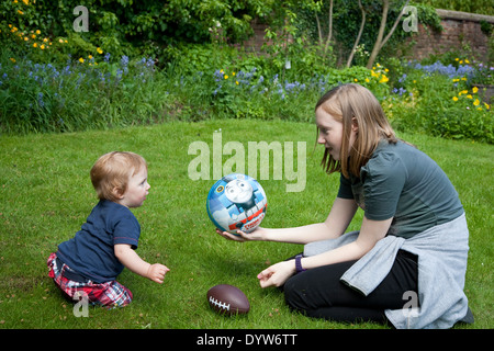 Children playing and having fun in a garden in summer. Stock Photo