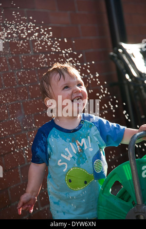 Thomas, Toddler, 13 months old playing with water Stock Photo