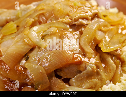 poulet yassa sénégalais.roasted chickens .Yassa is a spicy marinated food prepared with poultry.Originally from Senegal, Stock Photo