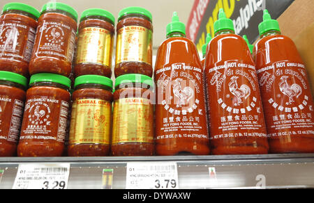 Aliso Viejo, California, USA. 25th Apr, 2014. Sriracha hot sauce products on sale in a California supermarket. Huy Fong Foods Sriracha plant in Irwindale that produces the popular Sriracha hot sauce has 90 days to contain its fumes after a decision by a California city council to label it a public nuisance. The Irwindale City Council's resolution enables officials to make changes if the smells continue after the factory's deadline has past. The factory had been working with the South Coast Air Quality Management District on the filtration system since complaints from residents first happened. Stock Photo