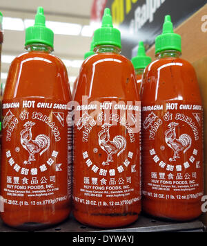 Aliso Viejo, California, USA. 25th Apr, 2014. Sriracha hot sauce on sale in a California supermarket. Huy Fong Foods Sriracha plant in Irwindale that produces the popular Sriracha hot sauce has 90 days to contain its fumes after a decision by a California city council to label it a public nuisance. The Irwindale City Council's resolution enables officials to make changes if the smells continue after the factory's deadline has past. The factory had been working with the South Coast Air Quality Management District on the filtration system since complaints from residents first happened. Irwindal Stock Photo