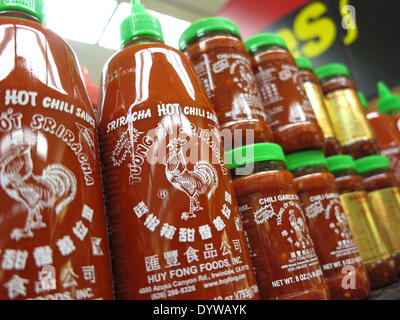 Aliso Viejo, California, USA. 25th Apr, 2014. Sriracha hot sauce products on sale in a California supermarket. Huy Fong Foods Sriracha plant in Irwindale that produces the popular Sriracha hot sauce has 90 days to contain its fumes after a decision by a California city council to label it a public nuisance. The Irwindale City Council's resolution enables officials to make changes if the smells continue after the factory's deadline has past. The factory had been working with the South Coast Air Quality Management District on the filtration system since complaints from residents first happened. Stock Photo