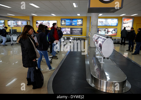 passengers waiting at baggage carousel at Presidente Carlos Ibanez del campo international Punta Arenas airport Chile Stock Photo