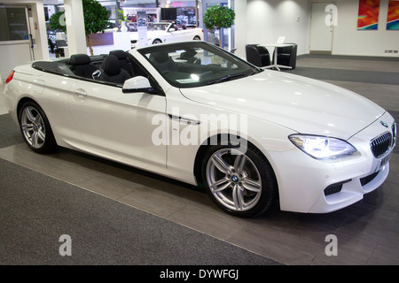 Brand new White BMW 6 Series M Sport Convertible 2 door 640d with roof down in car showroom Stock Photo