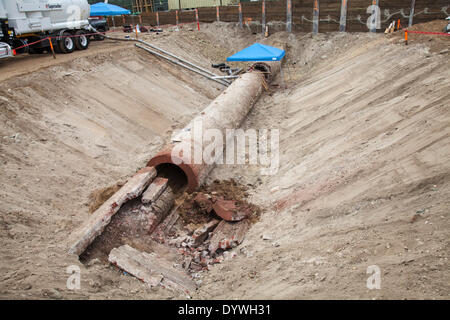 Los Angeles, CA, USA. 25th Apr, 2014. Workers clean out a section and prepare the recently unearthed Zanja Madre, or Mother Ditch, for removal to the nearby Metabolic Studios for safe keeping. The 100 foot section and 4 foot diameter of brick pipe was found at a construction site at Chinatown and is a remnant of the 90 mile network of channels that brought water to the early inhabitants of Los Angeles. Originally built in 1781 it was enclosed in 1877 and eventually abandoned in 1904. Credit:  Ambient Images Inc./Alamy Live News Stock Photo