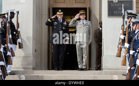 US Chairman of the Joint Chiefs Gen. Martin E. Dempsey and French Chief of Defense Staff Gen. Pierre de Villiers salute in front of the Pentagon during an honor cordon April 23, 2014 in Arlington, Virginia. Stock Photo