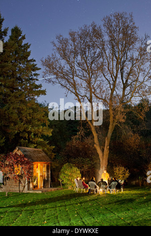 GLEN WILLIAMS, HALTON HILLS, ONTARIO, CANADA - October 15, 2010: Family and friends sit around a campfire in a backyard. Stock Photo