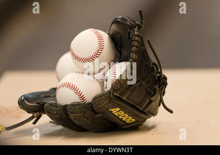 Milwaukee, Wisconsin, USA. 25th Apr, 2014. April 25, 2014: A glove sits in the dugout filled with baseballs just prior to the start of the Major League Baseball game between the Milwaukee Brewers and the Chicago Cubs at Miller Park in Milwaukee, WI. John Fisher/CSM/Alamy Live News Stock Photo