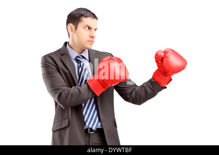 Businessman in suit with red boxing gloves posing Stock Photo