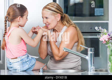grandmother and child girl cooking home kitchen Stock Photo
