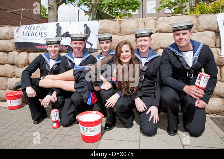 West Wickham, UK. 26th April 2014. A Crystal Palace cheer leader with H.M.S. Raleigh sailors collecting money for the Help for Heroes charity outside the Swan pub in West Wickham Kent Credit: Keith Larby/Alamy Live News Stock Photo