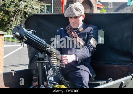 Larne, Northern Ireland. 26 Apr 2014 - A man wearing clothing from 1914 with a Vickers medium machine gun in the back of an old pick-up truck Credit:  Stephen Barnes/Alamy Live News Stock Photo