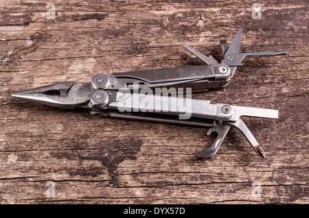 multitool, multi purpose tool on wood Stock Photo