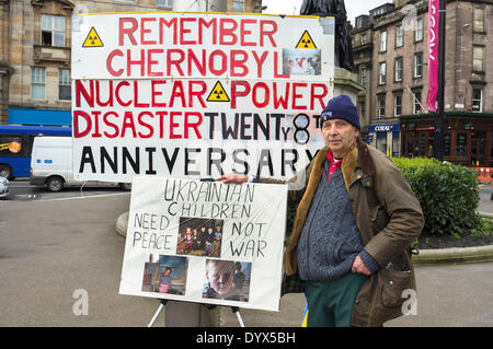 Glasgow, Scotland, UK. 26th Apr, 2014. Jim Gillies, aged 74, retired electrician from Cumbernauld near Glasgow, Scotland, UK, has carried out a 'one man' remembrance vigil, every year for the past 27 years, on the anniversary of the nuclear power plant explosion at the Ukrainian reactor in Chernobyl where 31 people died and 500,000 people were affected. Jim Gillies has visited the disaster area 16 times carrying out humanitarian work and has also been on the 'Black Tour' around the radioactive plant. Credit:  Findlay/Alamy Live News Stock Photo