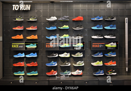 Colorful display of men's running shoes at Niketown sporting goods store on FIfth Avenue in lower Manhattan, New York City Stock Photo