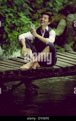 man in the lake wearing a suit and using a smart phone Stock Photo