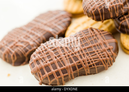 Gourmet Chocolate covered Nutter Butters with chocolate design on top. Stock Photo