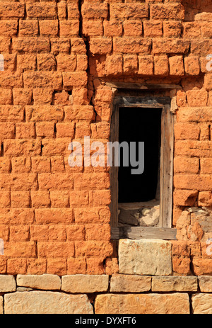 Empty wooden window frame in ruin red brick wall Stock Photo