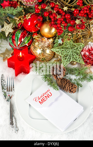 festive christmas table place setting decoration with red candle Stock Photo