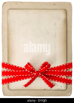 vintage card with red ribbon bow isolated on white background. grunge paper cardboard Stock Photo