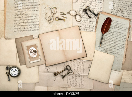 open book, vintage accessories, old letters, post cards, glasses, keys, clock. nostalgic background Stock Photo