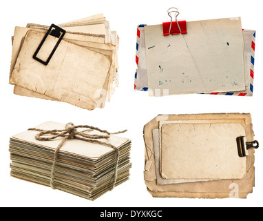 pile of old postcards isolated on white background. vintage paper sheets with clip. air mail envelope. retro design Stock Photo