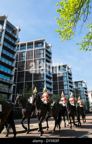 Household cavalry ride past One Hyde Park apartment buildings in Knightsbridge London United Kingdom Stock Photo