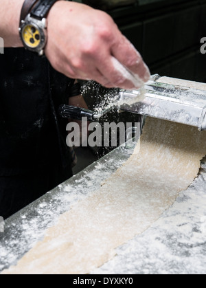 Making Tortellini pasta flattening the dough Stock Photo