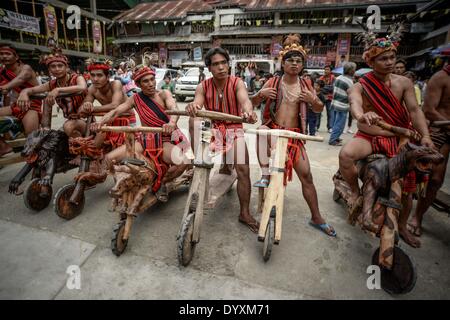 Banaue, Philippines. 27th Apr, 2014. Ifugao tribesmen ride wooden scooters during the Imbayah festival in Banaue town, Ifugao province, northern Philippines, April 27, 2014. The Imbayah festival is a celebration of Ifugao culture and thanksgiving, a gathering of the many tribes that make up the population of the Ifugao Rice Terraces, a UNESCO World Heritage site.Photo: Ezra Acayan/NurPhoto Credit:  Ezra Acayan/NurPhoto/ZUMAPRESS.com/Alamy Live News Stock Photo