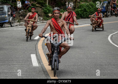 Banaue, Philippines. 27th Apr, 2014. Ifugao tribesmen ride wooden scooters during the Imbayah festival in Banaue town, Ifugao province, northern Philippines, April 27, 2014. The Imbayah festival is a celebration of Ifugao culture and thanksgiving, a gathering of the many tribes that make up the population of the Ifugao Rice Terraces, a UNESCO World Heritage site.Photo: Ezra Acayan/NurPhoto Credit:  Ezra Acayan/NurPhoto/ZUMAPRESS.com/Alamy Live News Stock Photo