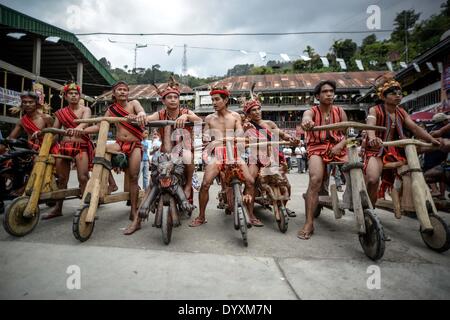 Banaue, Philippines. 27th Apr, 2014. Ifugao tribesmen ride wooden scooters during the Imbayah festival in Banaue town, Ifugao province, northern Philippines, April 27, 2014. The Imbayah festival is a celebration of Ifugao culture and thanksgiving, a gathering of the many tribes that make up the population of the Ifugao Rice Terraces, a UNESCO World Heritage site.Photo: Ezra Acayan/NurPhoto Credit:  Ezra Acayan/NurPhoto/ZUMAPRESS.com/Alamy Live News Stock Photo