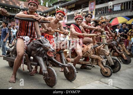 Banaue, Philippines. 27th Apr, 2014. Ifugao tribesmen ride wooden scooters during the Imbayah festival in Banaue town, Ifugao province, northern Philippines, April 27, 2014. The Imbayah festival is a celebration of Ifugao culture and thanksgiving, a gathering of the many tribes that make up the population of the Ifugao Rice Terraces, a UNESCO World Heritage site.Photo: Ezra Acayan/NurPhoto Credit:  Ezra Acayan/NurPhoto/ZUMAPRESS.com/Alamy Live News Stock Photo