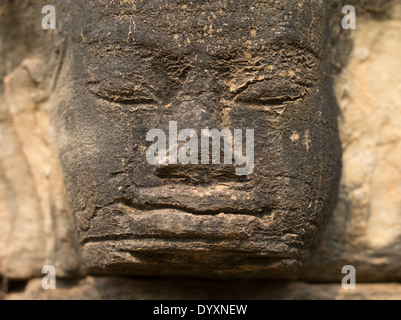 Stone carving of a face beside the Terrace of Elephants, Angkor Thom Temple, Siem Reap, Cambodia Stock Photo